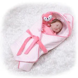 Detailed view of pink and white striped baby swaddle blanket with matching fox accessory