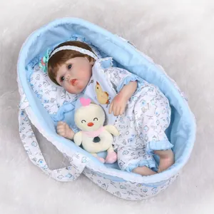 Realistic reborn baby doll in blue floral outfit with lace cradle and plush toy accessory