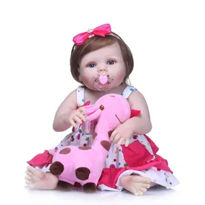 Realistic 50cm reborn baby doll with blue eyes, pink polka dot dress and giraffe plush