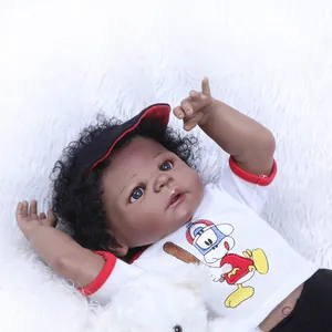 Realistic African American reborn baby doll with curly hair in a baseball outfit