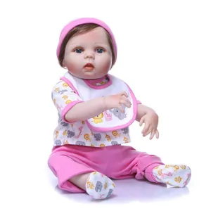 Realistic reborn baby doll in pink and white outfit with hat and socks on white background