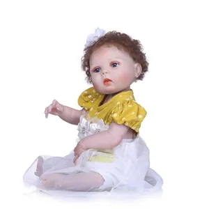 Detail of reborn doll with curly hair, floral headband, and yellow polka dot dress