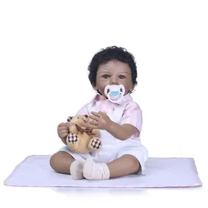 Lifelike African American reborn baby doll with curly hair, overalls and teddy bear