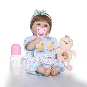 Realistic reborn baby doll with floral outfit, pacifier, and plush duck toy set