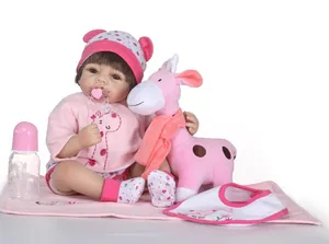 Detail of reborn baby doll in floral outfit with giraffe plush and feeding accessories