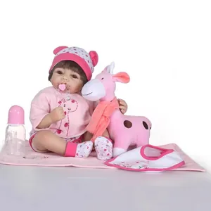 Lifelike reborn baby doll in pink hoodie with plush giraffe and feeding accessories