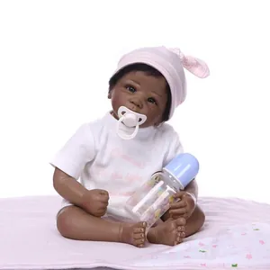 Realistic African American reborn baby doll with white outfit and pink striped hat
