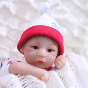 Lifelike reborn baby doll with polka dot knit hat and colorful patterned baby clothes