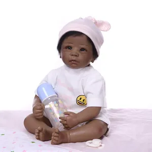 Black newborn baby doll in white smiley t-shirt with nursing bottle and pacifier
