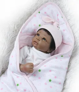 Detailed view of reborn baby doll in pink star sleeping bag on soft white fur background