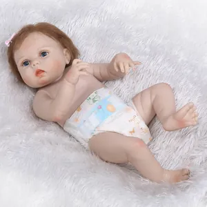 Close-up of realistic newborn baby doll with blue eyes, brown hair and pink bow headband