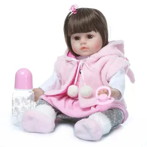 Realistic reborn baby doll in pink plush outfit with milk bottle and pacifier toy set