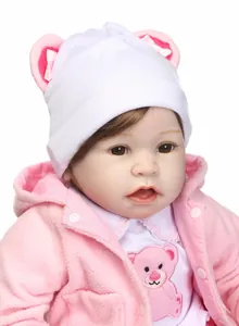 Detailed view of reborn doll face with brown eyes and pink fleece hooded jacket