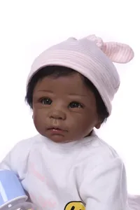 Detailed view of realistic African American reborn baby doll with hat and bottle