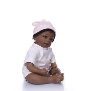 Detailed close-up of realistic African reborn baby doll in pink striped hat and white bodysuit