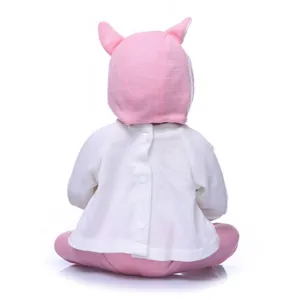 Back view of realistic baby doll in pink and white knitted cardigan with hood and ears
