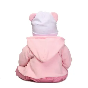 Lifelike baby doll in a pink fleece hoodie with cute ears shown from the back view