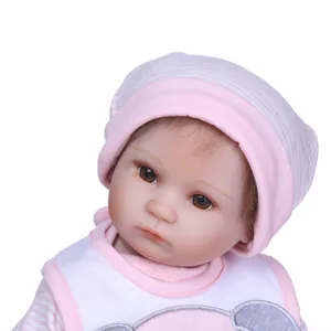 Realistic sleeping baby reborn doll in pink striped outfit with detailed facial features