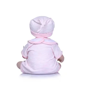 Detailed back view of reborn baby doll wearing pink and white striped cotton romper and hat