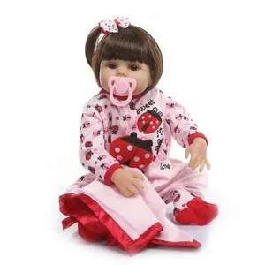 Realistic silicone baby doll with brown hair in ladybug outfit with pink pacifier