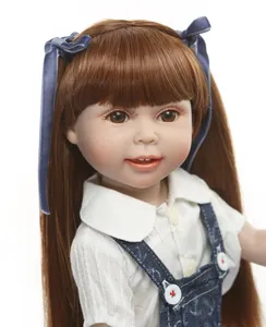 Close-up of realistic doll with long brown hair, blue bow, and denim overalls