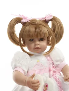 Detailed close-up of a lifelike reborn baby doll featuring blonde pigtails and lace dress