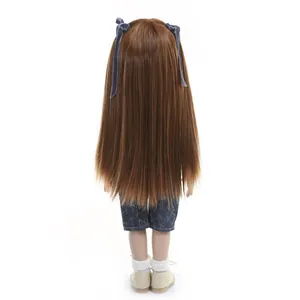 Realistic baby doll with long brown hair, blue floral pants and cream shoes, back view