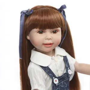 Realistic reborn girl doll with long brown hair in a blue denim overall skirt