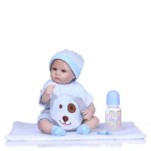 Detailed view of lifelike baby doll in blue striped outfit with pacifier and bottle