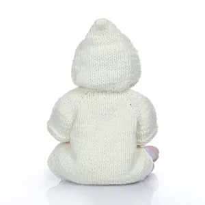 Macro detail of white knitted baby jumpsuit with soft hood and textured weave
