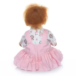 Detailed back view of a realistic newborn monkey doll wearing a pink ruffled dress