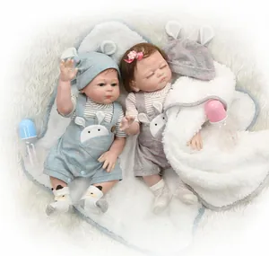 Detailed close-up of twin reborn baby dolls with realistic silicone skin and outfits