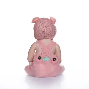 Detail view of the pink knitted outfit and lifelike skin texture on this reborn baby doll