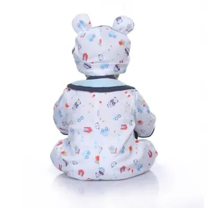 Cute realistic baby boy doll wearing a printed white romper with car and bear patterns