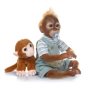 Lifelike baby orangutan doll in blue striped overalls with a small plush monkey