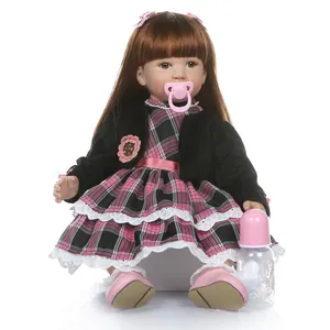 Reborn toddler girl doll with long brown hair in pink plaid dress with pacifier