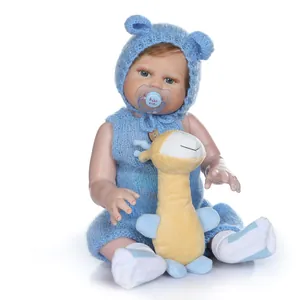 Realistic reborn baby doll in blue knit outfit with plush giraffe and pacifier