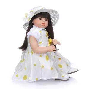 Realistic reborn baby doll girl with black hair in yellow polka dot dress and hat