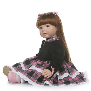 Realistic reborn toddler girl doll with long brown hair in pink and black checkered outfit