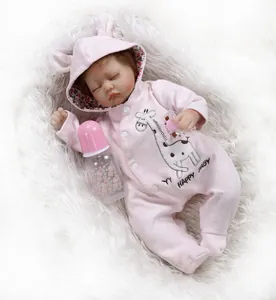 Detailed view of sleeping reborn baby doll in pink giraffe outfit with bottle and pacifier