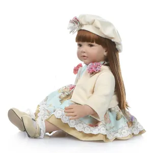 Realistic reborn toddler doll with long brown hair in vintage floral dress and beret