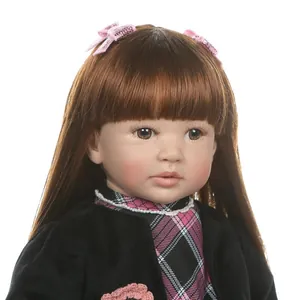 Realistic reborn toddler doll with long brown hair, sequins bows and plaid outfit