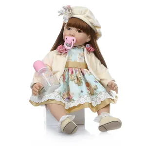 Realistic reborn toddler girl doll with long brown hair, floral dress and accessories
