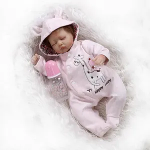 Realistic reborn baby doll in pink giraffe hoodie with bottle and pacifier on white fur