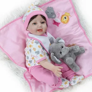 Lifelike reborn baby doll with pink polka dot hat, elephant plush toy and floral blanket