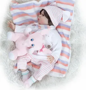 Realistic reborn baby doll in pink striped outfit with matching plush elephant toy