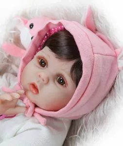 Close-up of silicone reborn baby doll face with realistic eyelashes and knit hoodie