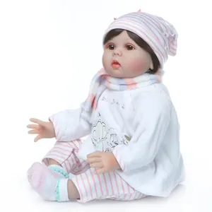 Realistic reborn baby doll in pink elephant outfit with hat and scarf set on white background