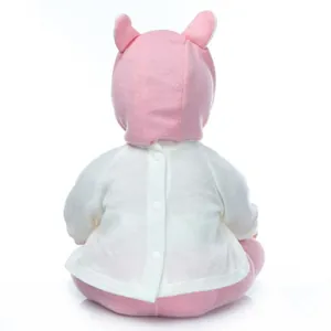 Detailed back view of a soft silicone reborn baby doll wearing a pink knit outfit with ears