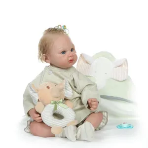 Realistic reborn baby doll with blonde curls and green outfit with elephant toy accessory